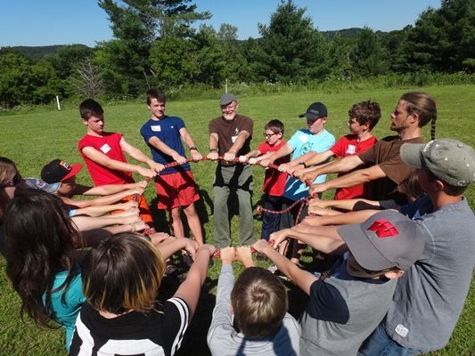 Boston Summer Camps | Teens in a circle working as a team